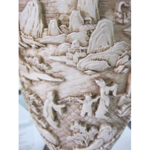 99 - A decorative Oriental style elephant-handled vase of carved effect resin on a wooden base,