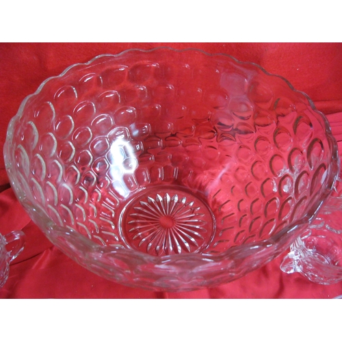 140 - A large punchbowl with 12 matching glasses and hooks to hang from edge of bowl, plus a further 6 gla... 