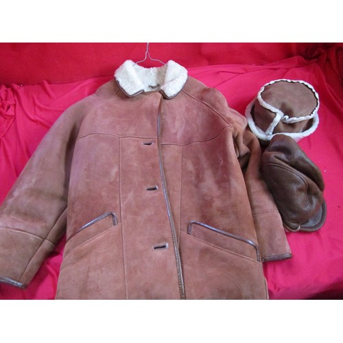 109 - A sheepskin car coat, ladies, in unworn condition, and two matching lined hats