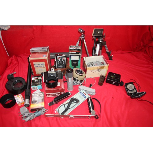 110 - A large box of photographic accessories including tripods, flash units, a monopod, cameras, developi... 