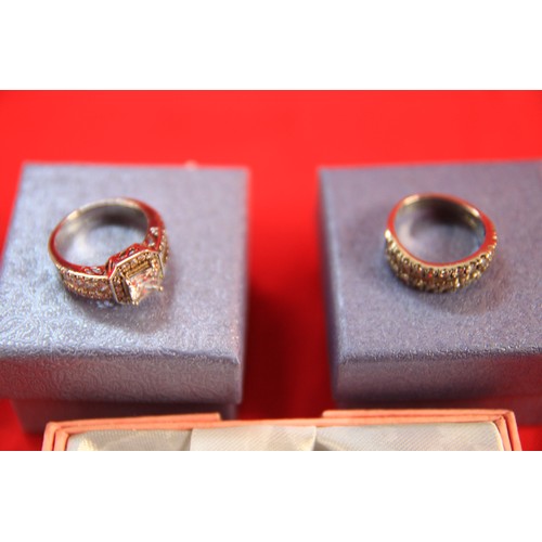 172A - A pair of boxed sterling silver rings with clear stone decoration plus a boxed silver heart pendant ... 