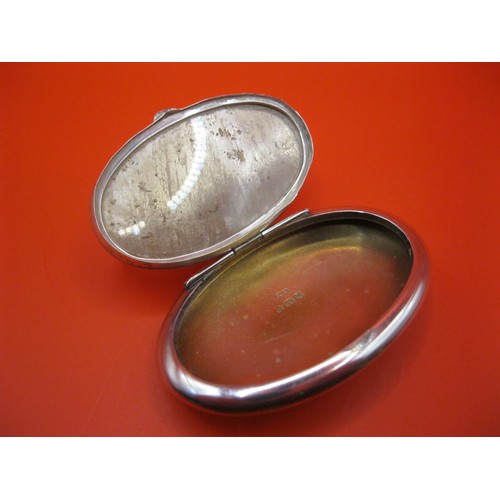 230 - A sterling silver snuff box with fob ring, of oval form, hallmarked for Birmingham 1915 by Crisford ... 