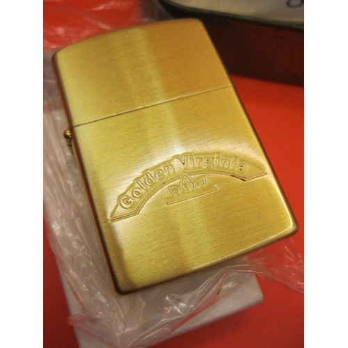 278 - A Zippo-style Golden Virginia lighter, boxed and unused, plus 3 promotional lighters, all contained ... 