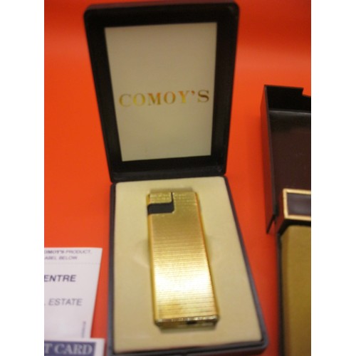 282 - A vintage Comoy cigarette lighter in original case with paperwork, appears unused, plus a Colibri li... 