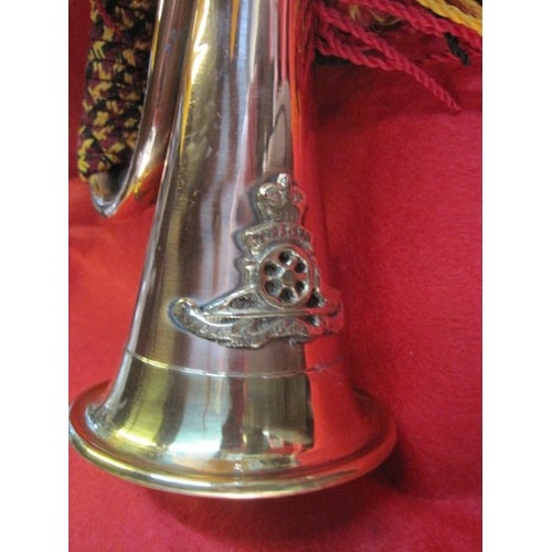 325 - A vintage brass bugle with cords and Royal Artillery badge