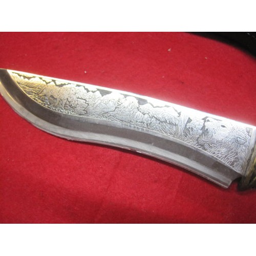 339 - A new and boxed ornate 'Lion Knife' with stand