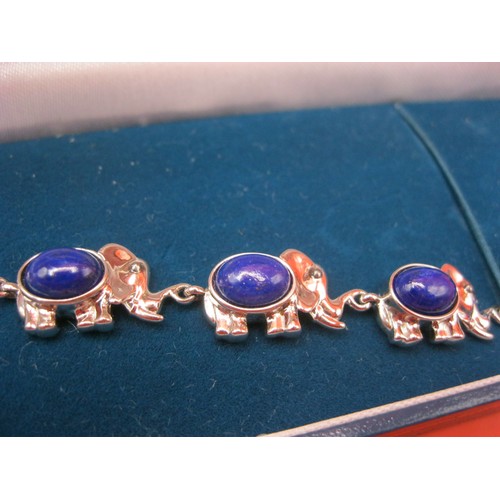 347 - A silver elephant parade bracelet set with lapis lazuli stones