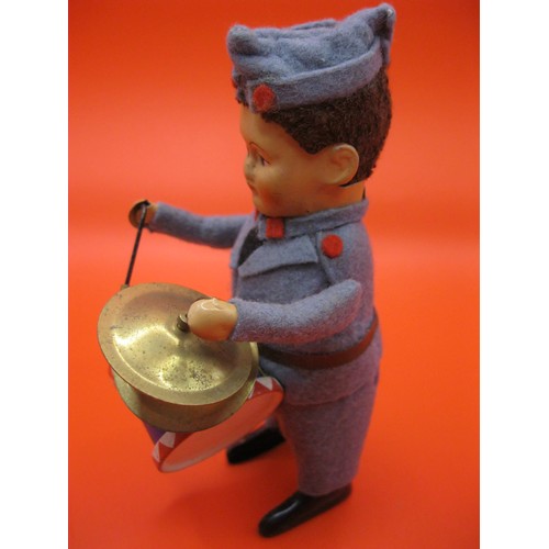 353 - A Schuco tinplate and felt clockwork drummer boy