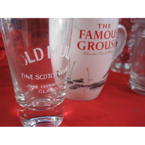 394 - A selection of branded whisky jugs and whisky glasses plus a decanter