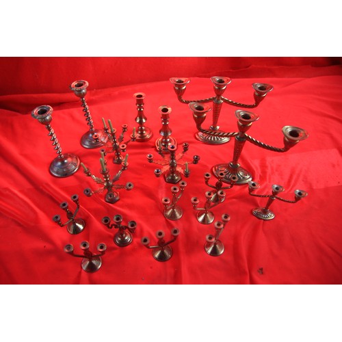15 - A large assortment of brass candlesticks of various sizes