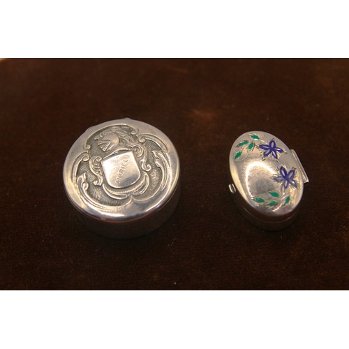 61 - A pair os snuff- or pill-boxes, one with enamel flora to the lid, the larger with a faux-armorial cr... 