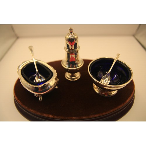 110 - A sterling silver condiment set with spoons and cobalt glass liners: the pepper hallmarked London 19... 