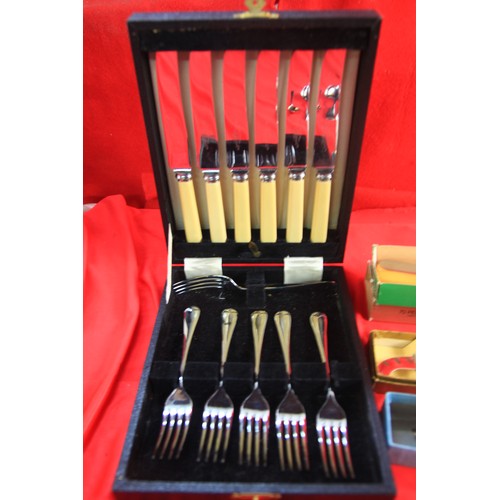 111 - An assortment of vintage cutlery, many items boxed and appearing unused, in silver plate and chromed... 