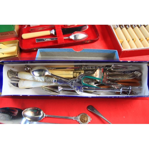 111 - An assortment of vintage cutlery, many items boxed and appearing unused, in silver plate and chromed... 