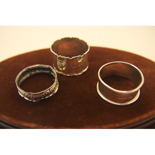 112 - Three .925 sterling silver napkin rings: one plain, hallmarked  for Birmingham, one with scrollwork-... 