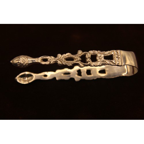 122 - An ornate pair of sterling silver sugar tongs, hallmarked for Chester 1896 by George Nathan & Ridley... 