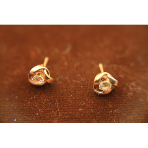 126 - A pair of 9carat gold & clear stone knot earrings, 0.8g