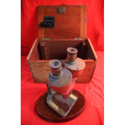 164 - A vintage cased stereoscopic microscope with accessories