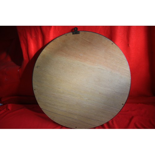 207 - A large, round bevel-edged mirror in a polished wood frame, in good order