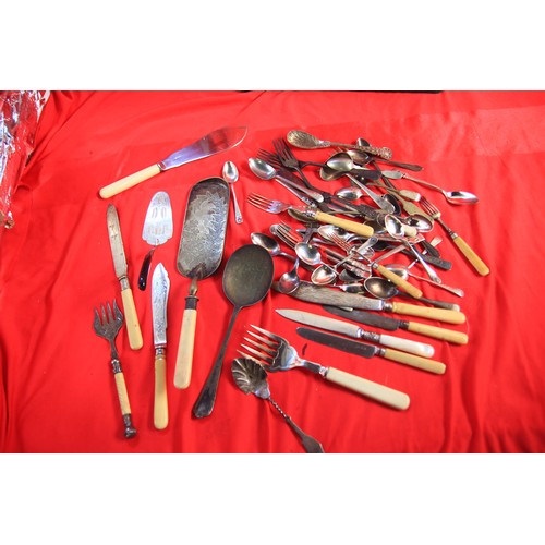 212 - A tray of cutlery items including some silver