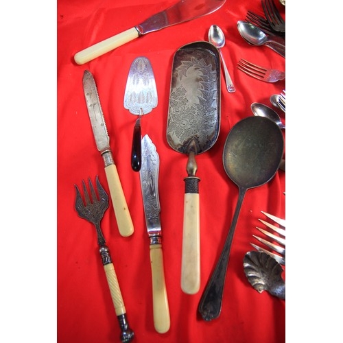 212 - A tray of cutlery items including some silver