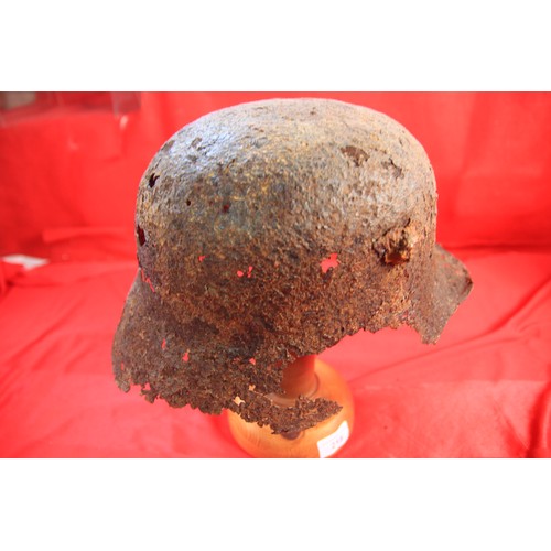 218 - A WW1 German Stahlhelm Helmet on a wooden stand, found during ploughing at Butte de Warlencourt, ver... 