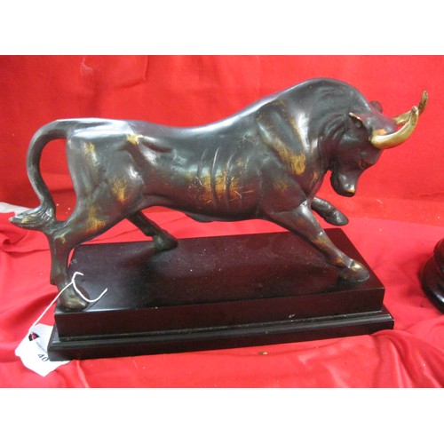 40 - A hollow metal figure of a bull with bronze effect finish, mounted on a plinth