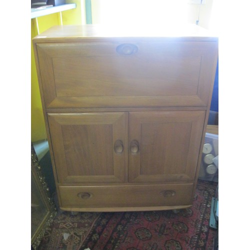 189 - An Ercol Windsor model 469 1960s retro beechwood cocktail or bureau cabinet with recessed oval handl... 