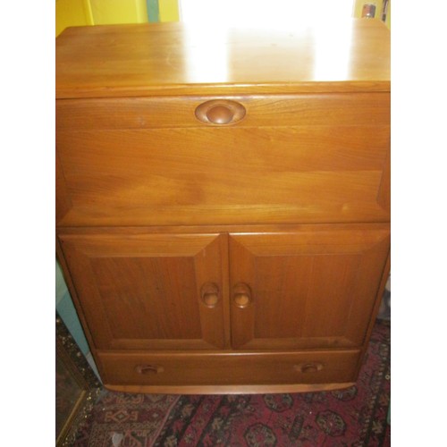 189 - An Ercol Windsor model 469 1960s retro beechwood cocktail or bureau cabinet with recessed oval handl... 