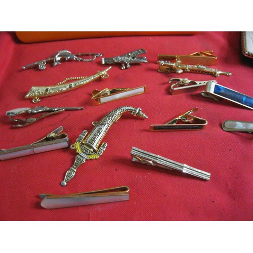 259 - A large tub full of vintage cuff links and tie-clips and -bars including ones shaped like aircraft, ... 