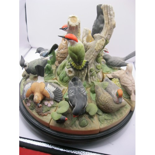 327 - A complete Danbury Mint 'Birds of the Forest' collection of rotating stand