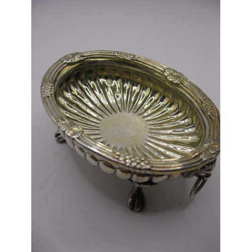 307 - An antique sterling silver mustard bowl with lion's head handles and claw feet, fluted decoration to... 