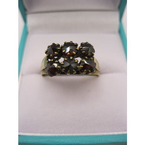 126 - A ring marked 333 for 8 carat gold set with 6 garnets, approx weight 2.5g, size Q