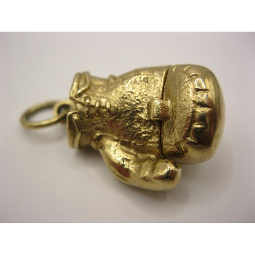 4 - A 9 carat gold locket in the form of a boxing glove which opens to reveal a miniature pair of boxers... 