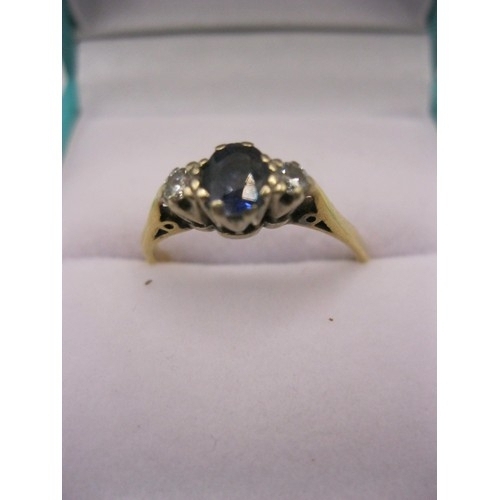 128 - An impressive 18 carat gold ring, slightly misshapen, set with a central sapphire flanked by diamond... 