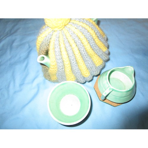 41 - Child`s tea set in a basket along with a teacosy and baby walker which has a full load of multicolou... 