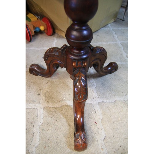 91 - An ornately inlaid table of some age, in good order, on tripod feet under a turned pedestal