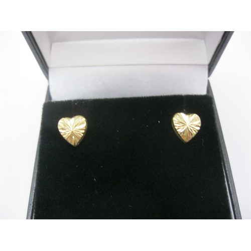 95 - A pair of 9 carat gold diamond cut heart-shaped earrings