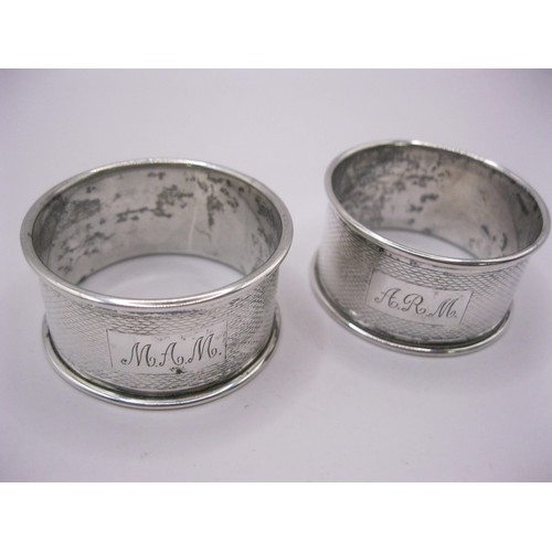 104 - A pair of heavy engine-turned napkin rings in sterling silver, hallmarked for Birmingham 1979 by CT ... 