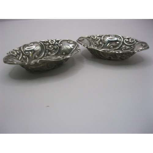 105 - A matching pair of small sterling silver trinket dishes with repousse decoration, hallmarked for Bir... 