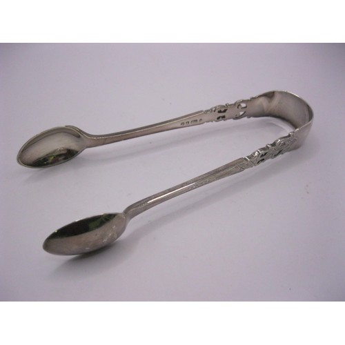 107 - A large pair of sugar tongs with pierced floral decor, hallmarks worn