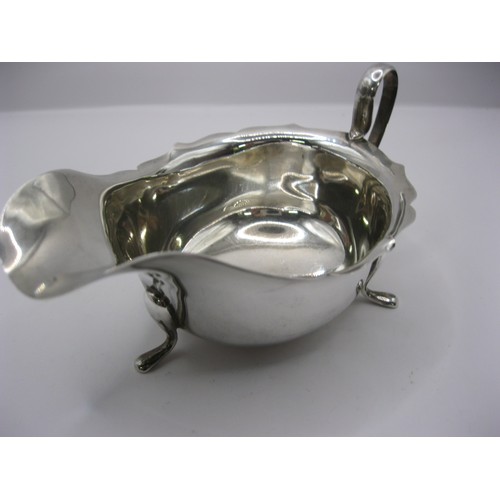 108 - A substantial sterling silver gravy boat on tripod feet, hallmarked for Sheffield 1932 by Edward Vin... 