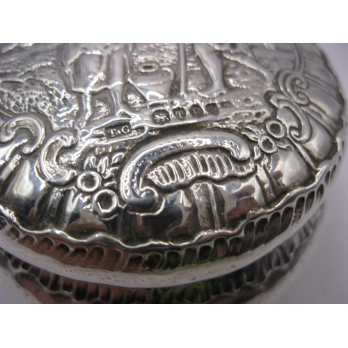 152 - An ornate embossed continental silver circular snuff box with lid, London import marks for 1894, app... 