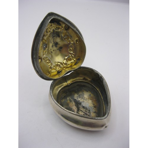 169 - A sterling silver snuff box of heart shape, with repousse decoration to top, hallmarked for Chester,... 