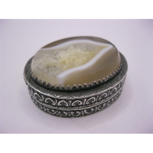 170 - A sterling silver snuff box with ornate sides and a yellow and white stone to the top