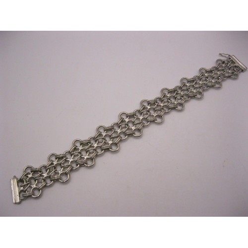 172 - A very decorative triple chain link bracelet in sterling silver