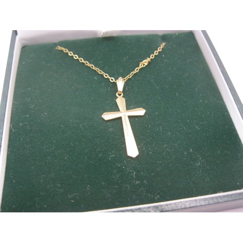 212 - A hallmarked 9 carat gold cross on a fine gold chain