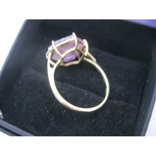 214 - A 9 carat gold faceted amethyst ring with diamond set shoulders, approx weight 2.9g, size Q