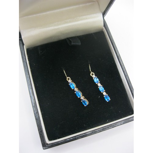 216 - A pair of 9 carat gold drop earrings set with blue apatite and small diamonds on hook wire fittings