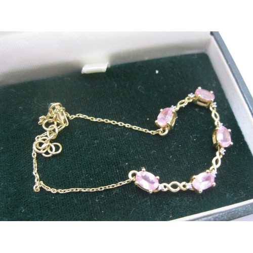 217 - An ornate 9 carat gold bracelet set with pink stones and small diamonds, approx weight 3.5g